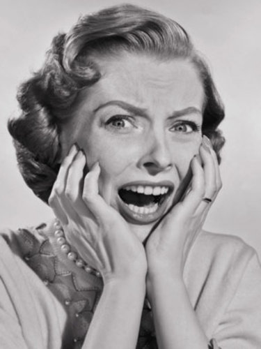 black and white photo of 1950s era woman screaming in horror movie
